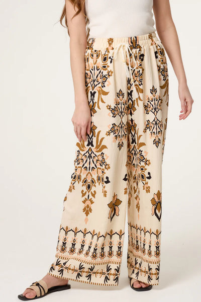 BORDER PRINT SAND WIDE LEG TROUSERS