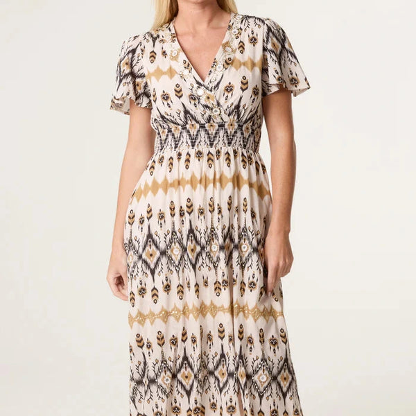 Woman wearing a patterned dress on a white background
