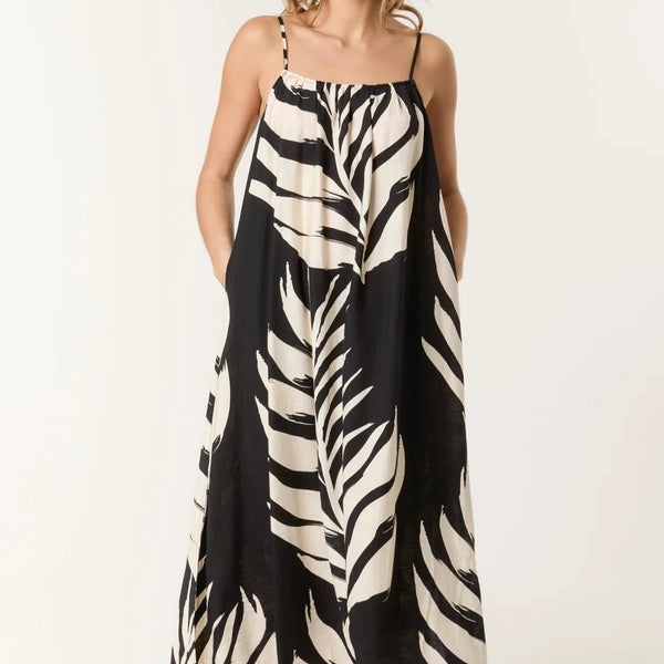 Woman wearing a zebra print dress on a white background